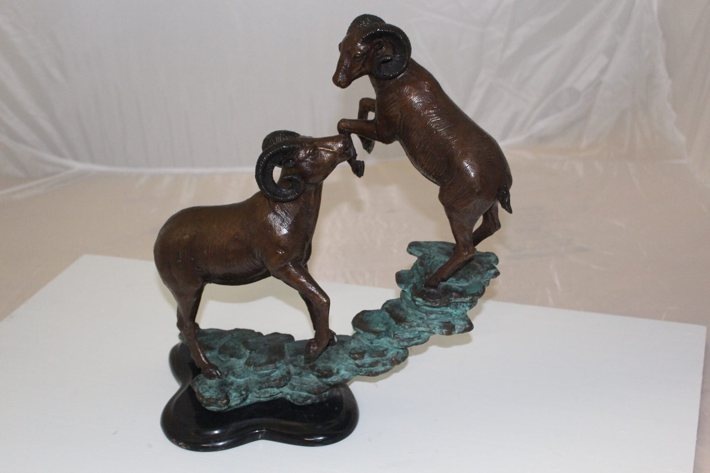 Two Rams on a rock Bronze Statue - Size: 15"L x 8"W x 16"H.
