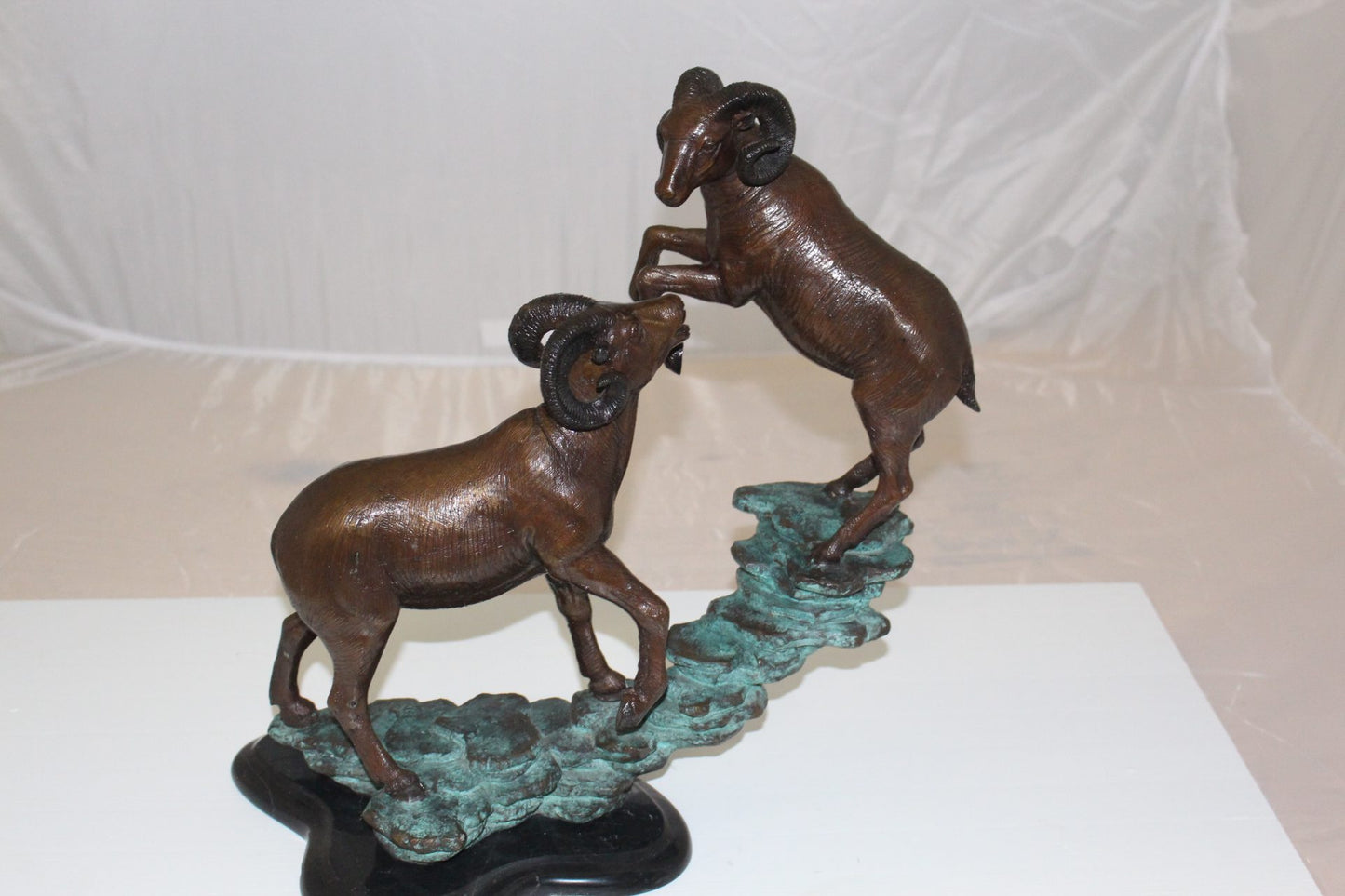 Two Rams on a rock Bronze Statue - Size: 15"L x 8"W x 16"H.