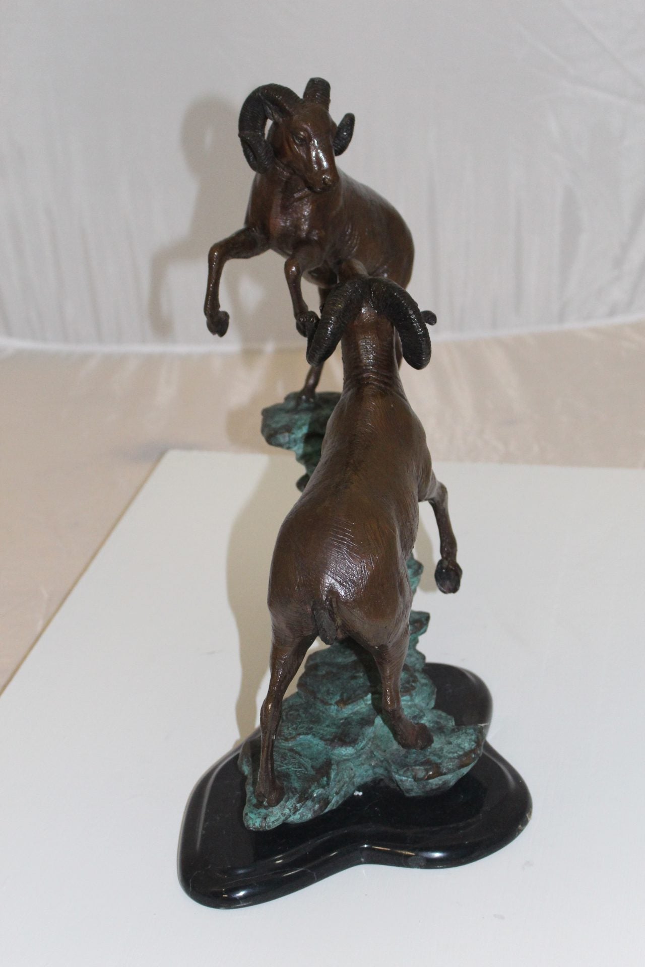 Two Rams on a rock Bronze Statue - Size: 15"L x 8"W x 16"H.