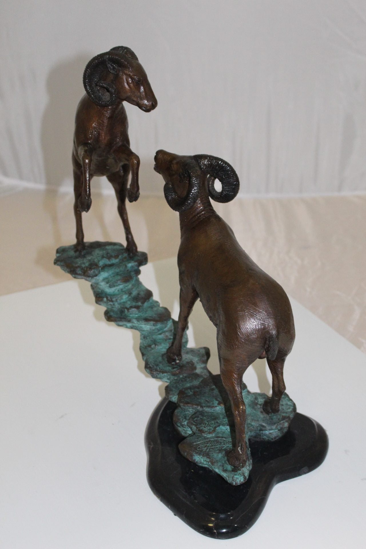 Two Rams on a rock Bronze Statue - Size: 15"L x 8"W x 16"H.