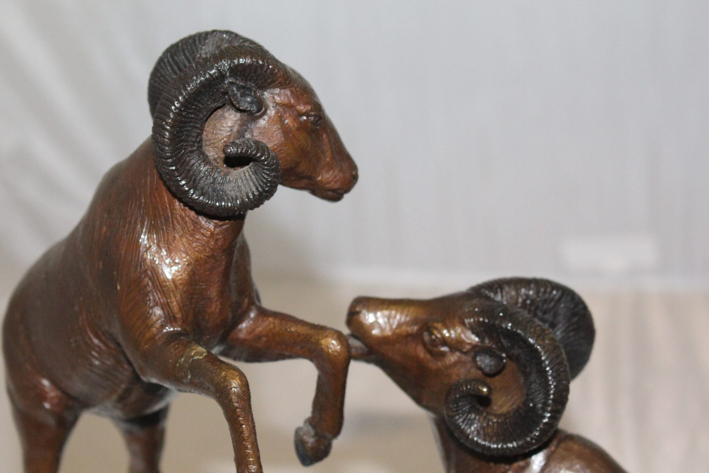 Two Rams on a rock Bronze Statue - Size: 15"L x 8"W x 16"H.