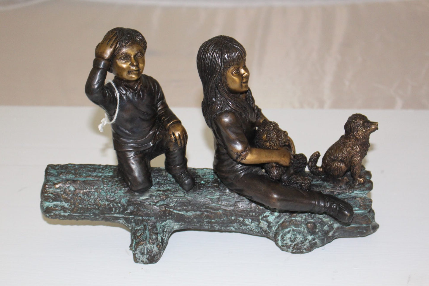 Two kids with dog on log Bronze Statue - Size: 12"L x 5"W x 8.5"H.