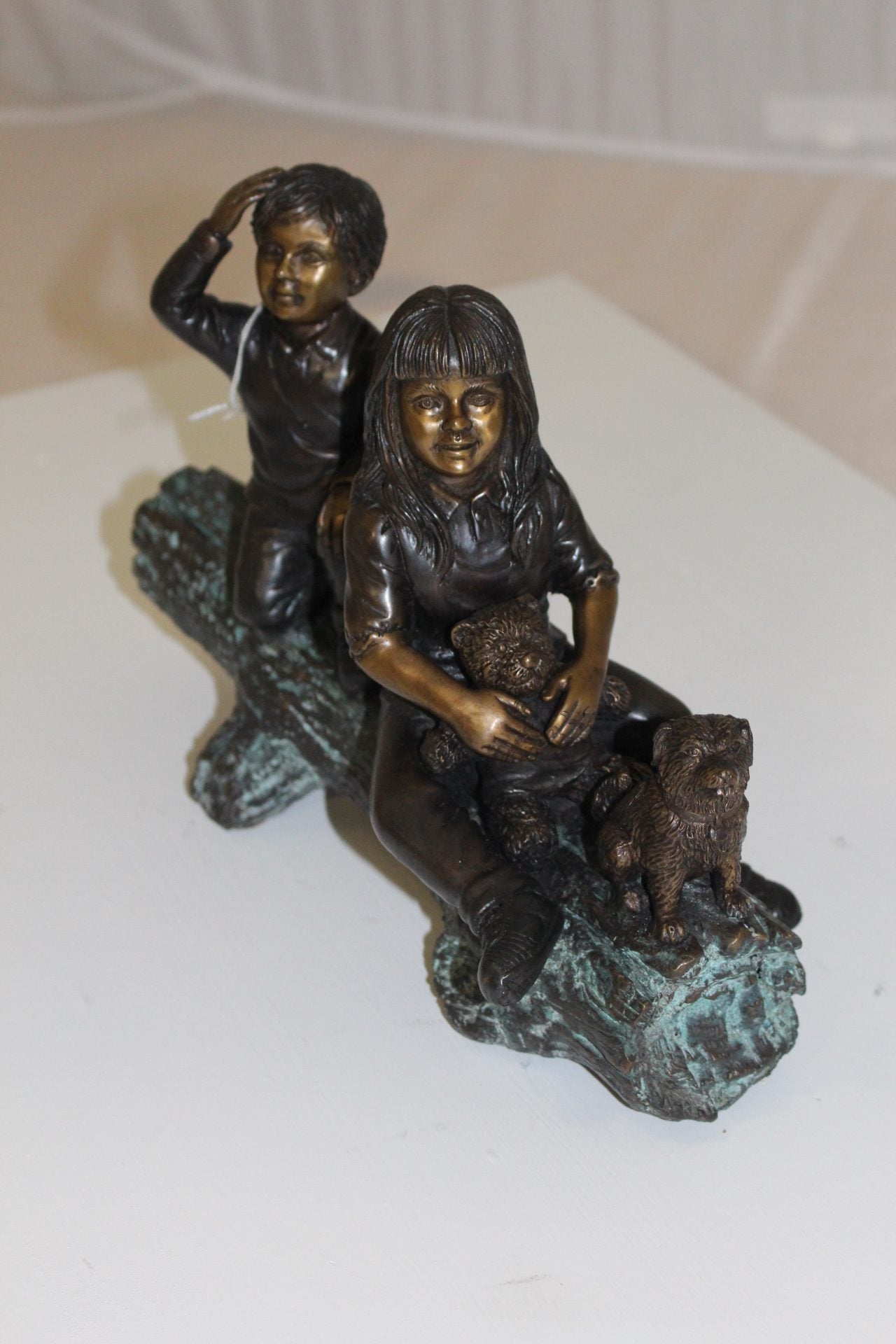 Two kids with dog on log Bronze Statue - Size: 12"L x 5"W x 8.5"H.