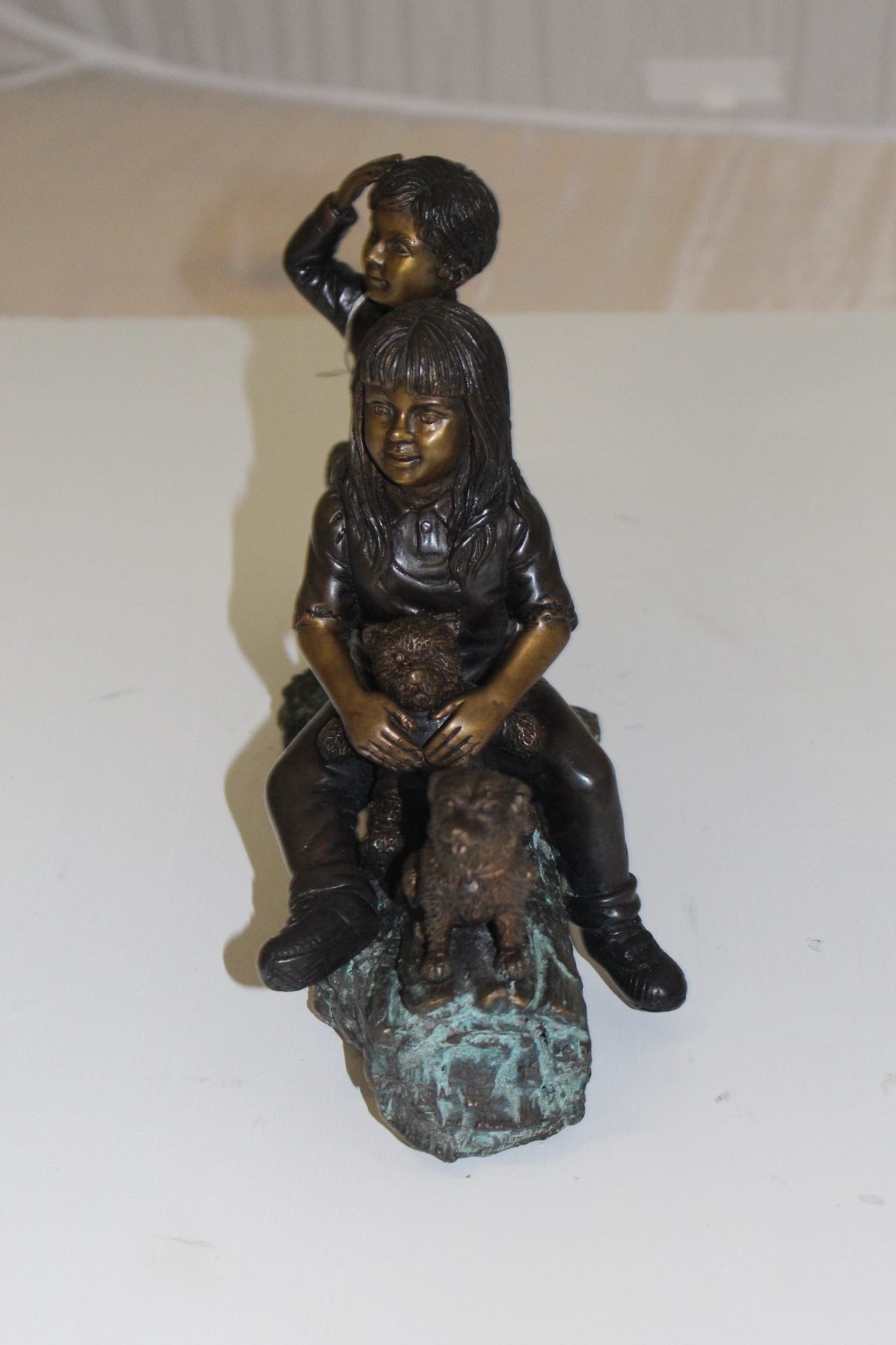 Two kids with dog on log Bronze Statue - Size: 12"L x 5"W x 8.5"H.