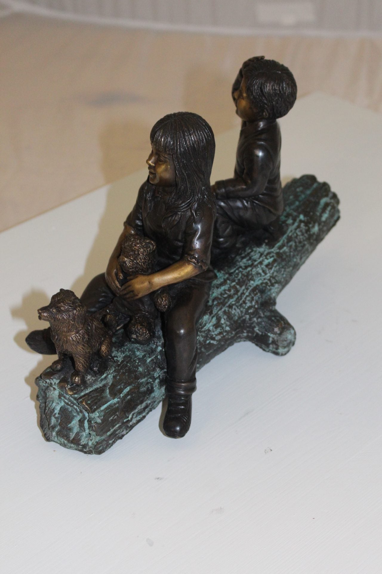 Two kids with dog on log Bronze Statue - Size: 12"L x 5"W x 8.5"H.