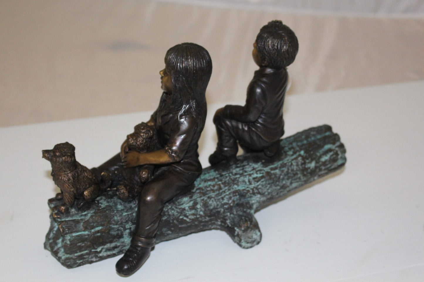 Two kids with dog on log Bronze Statue - Size: 12"L x 5"W x 8.5"H.