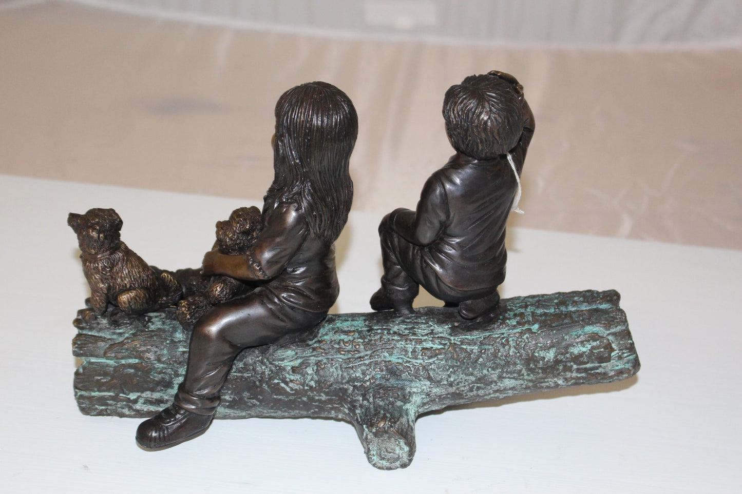 Two kids with dog on log Bronze Statue - Size: 12"L x 5"W x 8.5"H.