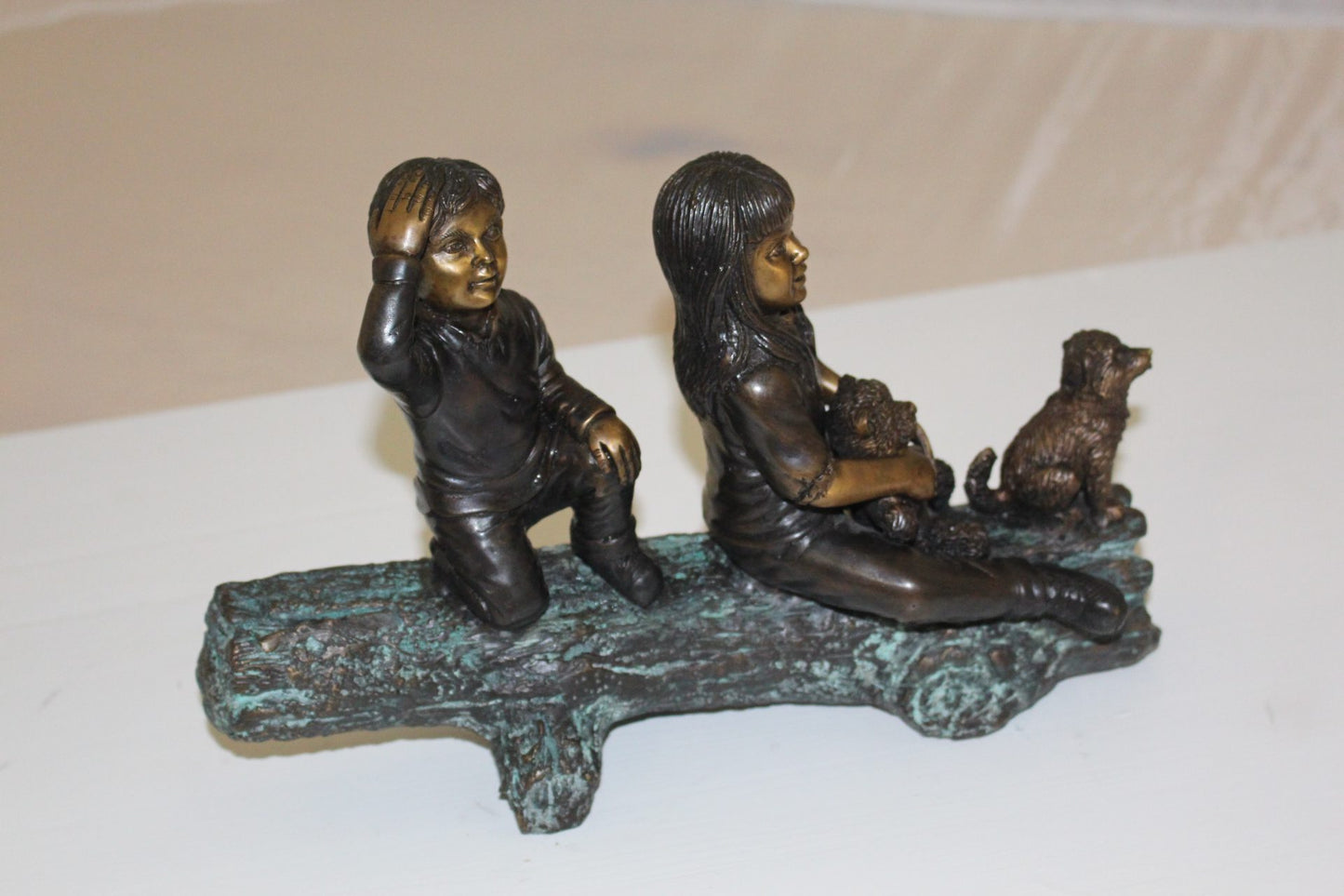 Two kids with dog on log Bronze Statue - Size: 12"L x 5"W x 8.5"H.