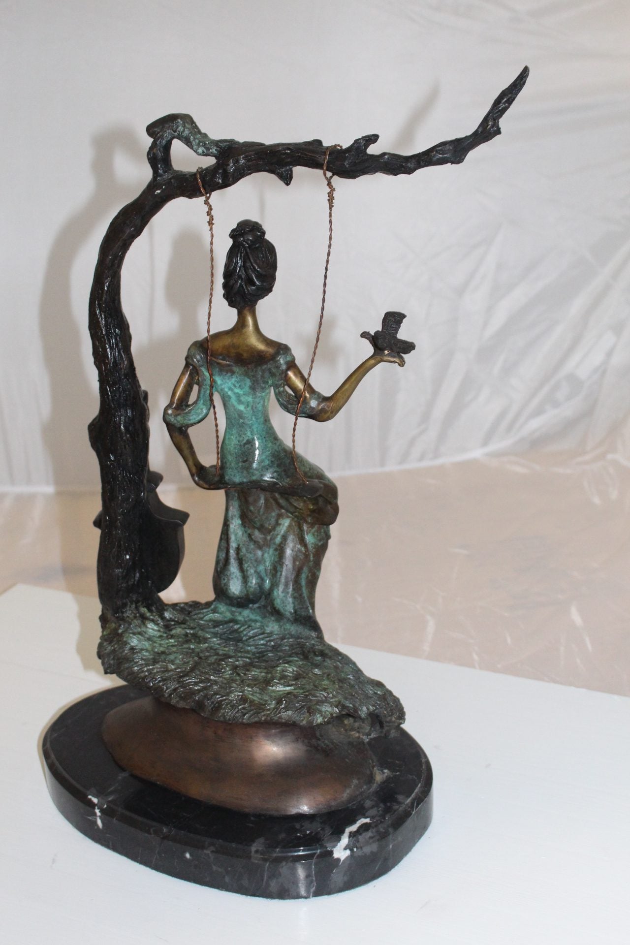 Girl on a swing Bronze Statue - Size: 15"L x 8"W x 21"H.