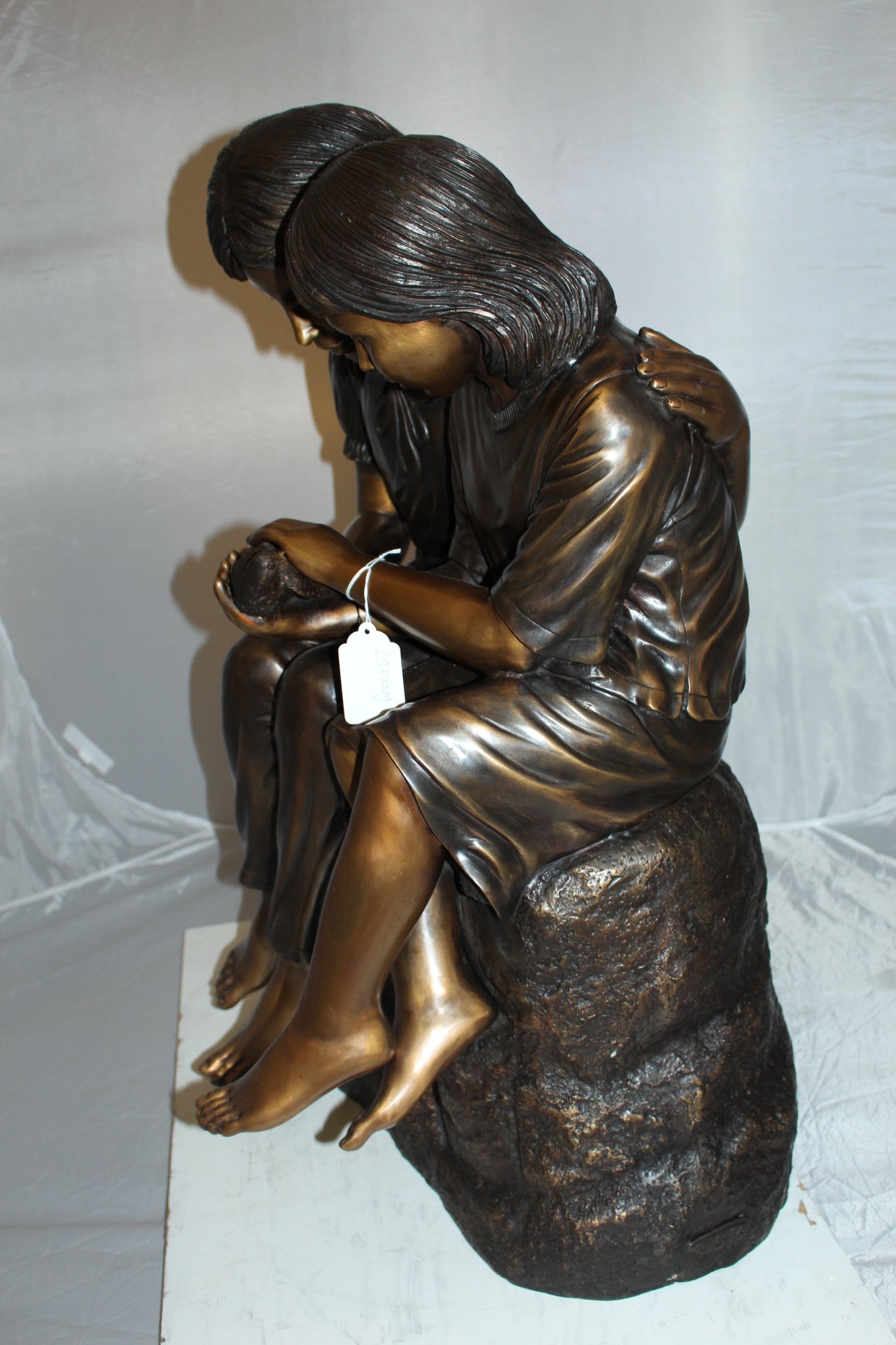 Two kids holding a bird Bronze Statue - Size: 18"L x 26"W x 34"H.