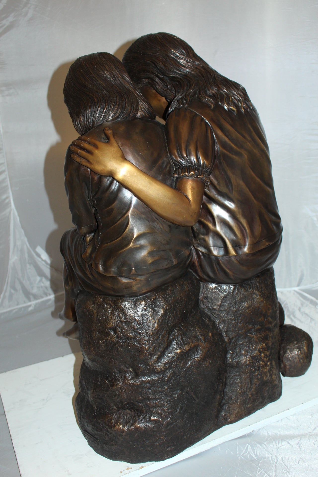 Two kids holding a bird Bronze Statue - Size: 18"L x 26"W x 34"H.
