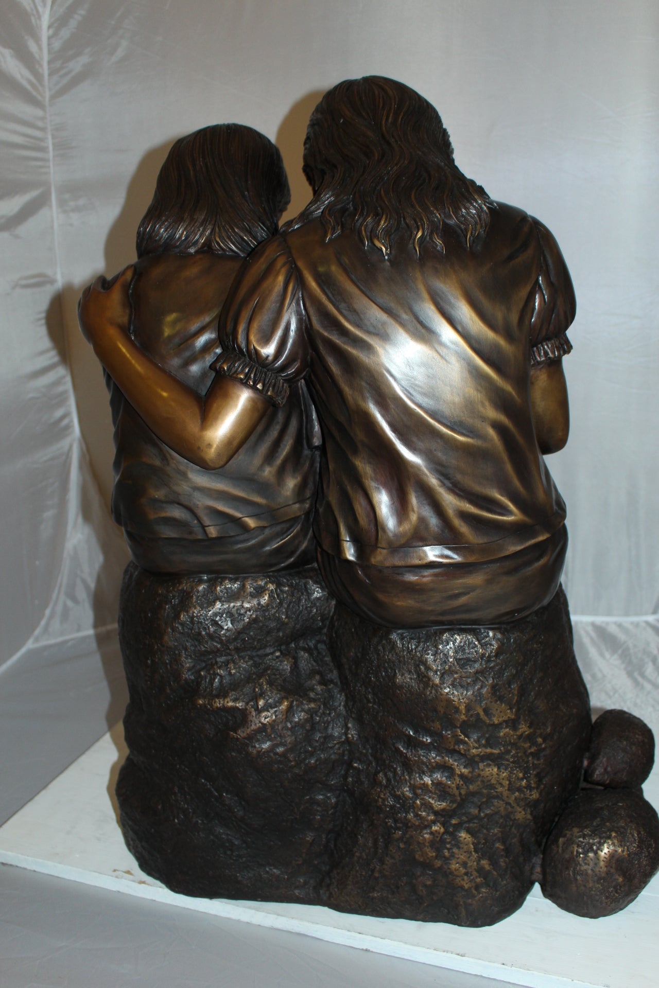 Two kids holding a bird Bronze Statue - Size: 18"L x 26"W x 34"H.