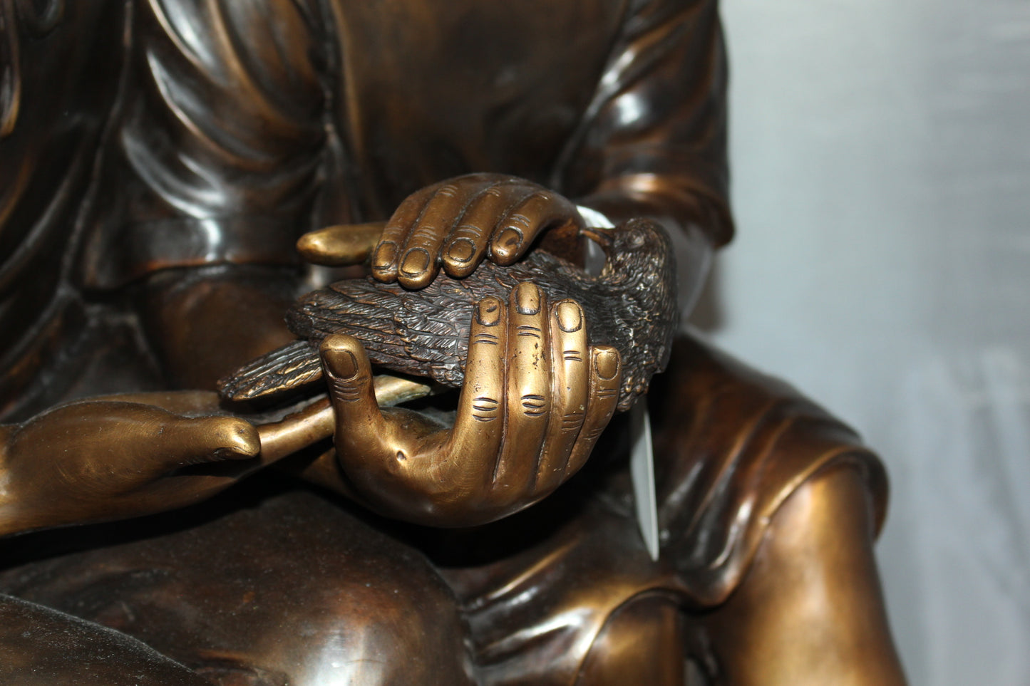 Two kids holding a bird Bronze Statue - Size: 18"L x 26"W x 34"H.
