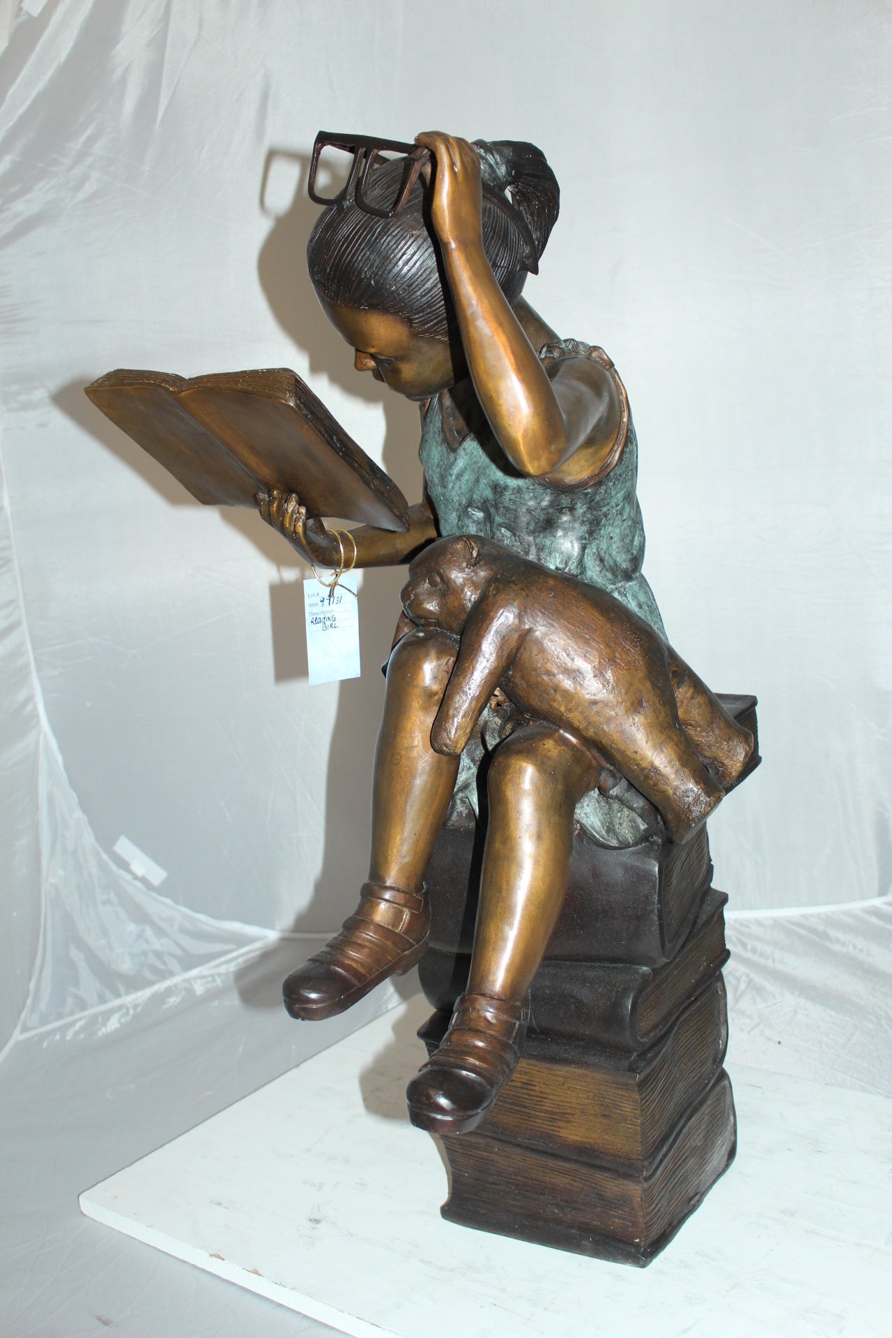 Girl sitting on a stack of books reading a book Bronze Statue - 17"x 18"x 36"H