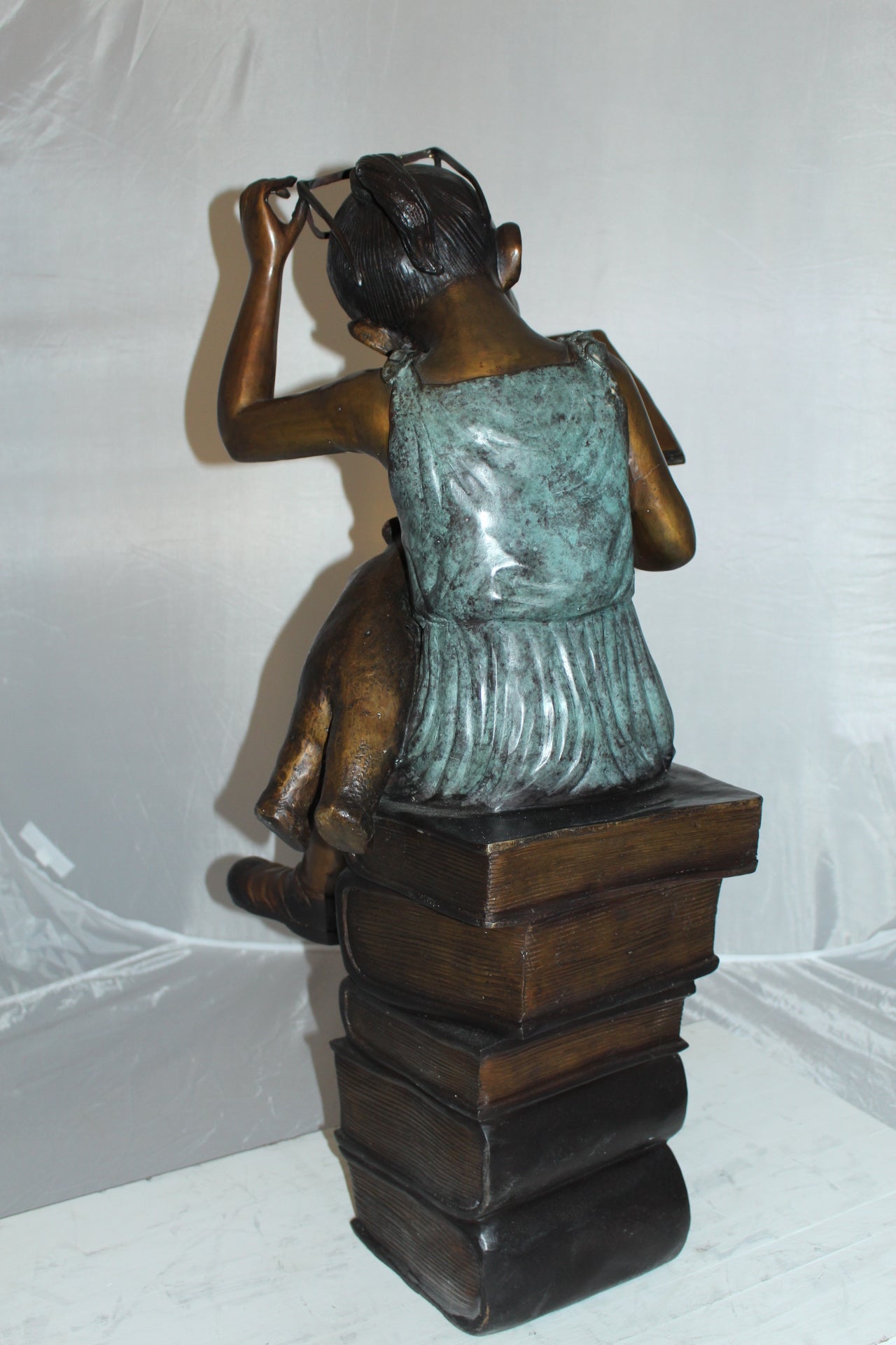 Girl sitting on a stack of books reading a book Bronze Statue - 17"x 18"x 36"H