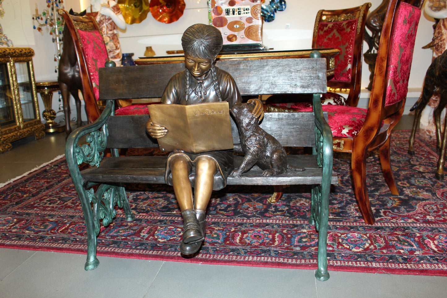 Girl sitting with her dog on a bench, reading Bronze Statue - 27" x 39" x 32"H