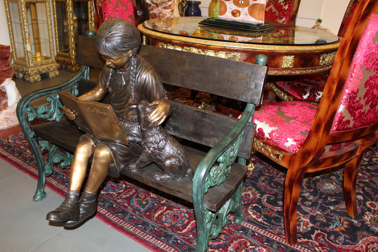 Girl sitting with her dog on a bench, reading Bronze Statue - 27" x 39" x 32"H