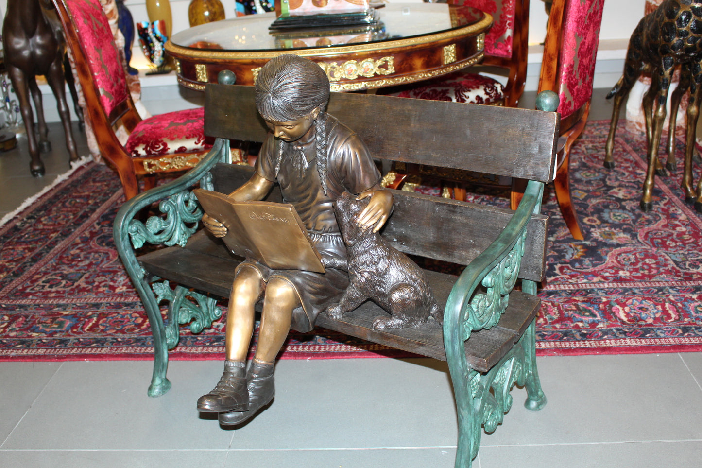 Girl sitting with her dog on a bench, reading Bronze Statue - 27" x 39" x 32"H