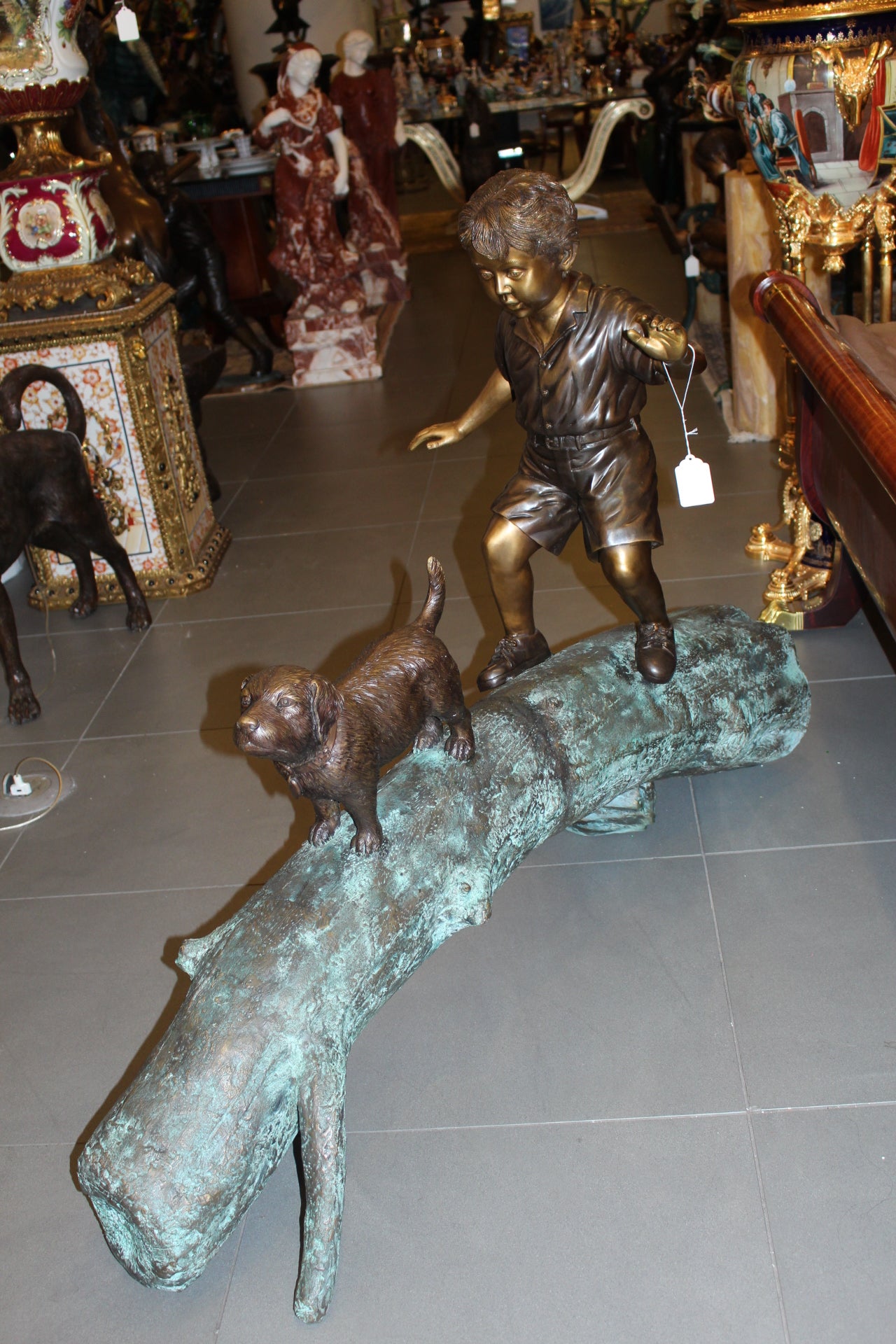 Kid with dog walking on a log Bronze Statue -  Size: 57"L x 18"W x 41"H.