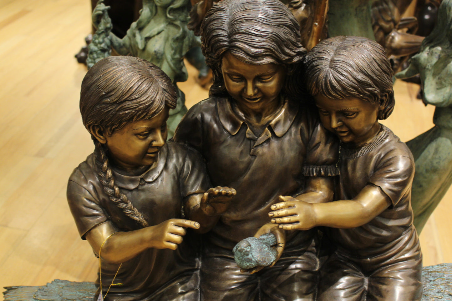 Three Children On Log Holding Bird Bronze Statue - Size: 55"L x 18"W x 38"H.