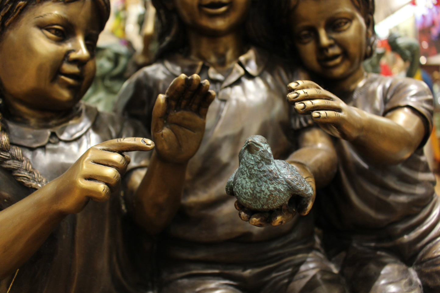 Three Children On Log Holding Bird Bronze Statue - Size: 55"L x 18"W x 38"H.