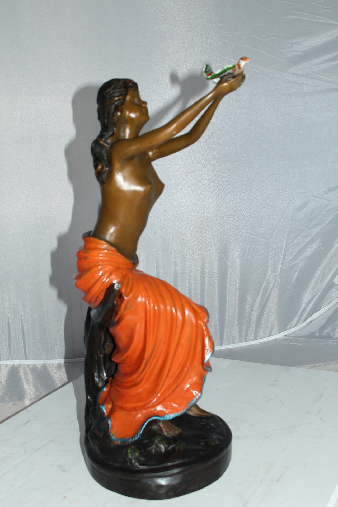 Lady Holds a Bird Up Bronze Statue - Size: 7"L x 7"W x 20"H.