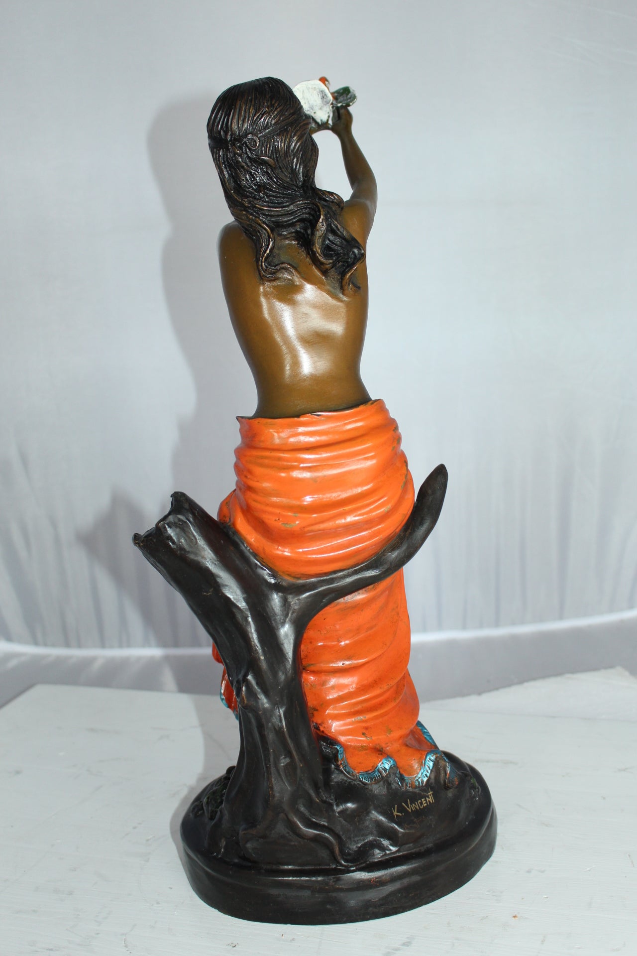 Lady Holds a Bird Up Bronze Statue - Size: 7"L x 7"W x 20"H.