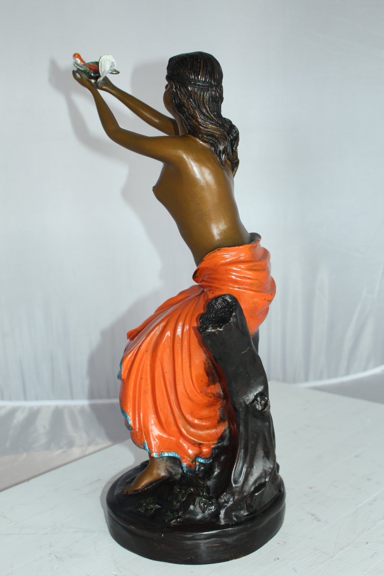 Lady Holds a Bird Up Bronze Statue - Size: 7"L x 7"W x 20"H.