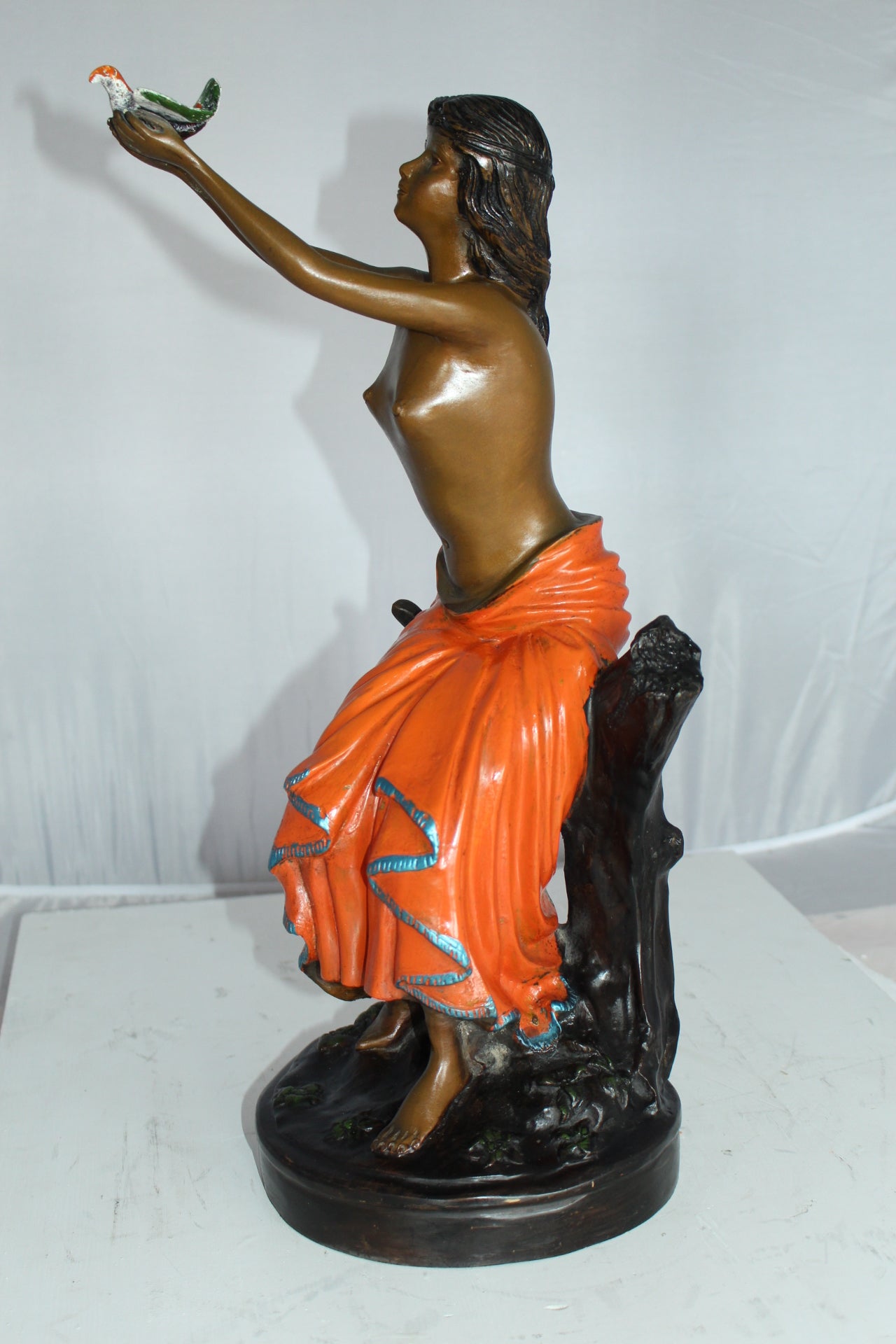 Lady Holds a Bird Up Bronze Statue - Size: 7"L x 7"W x 20"H.