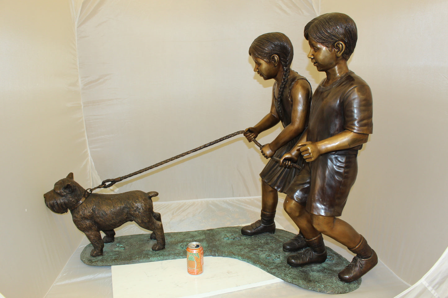 Two Kids Walking a dog Bronze Statue - Size: 55"L x 28"W x 37"H.