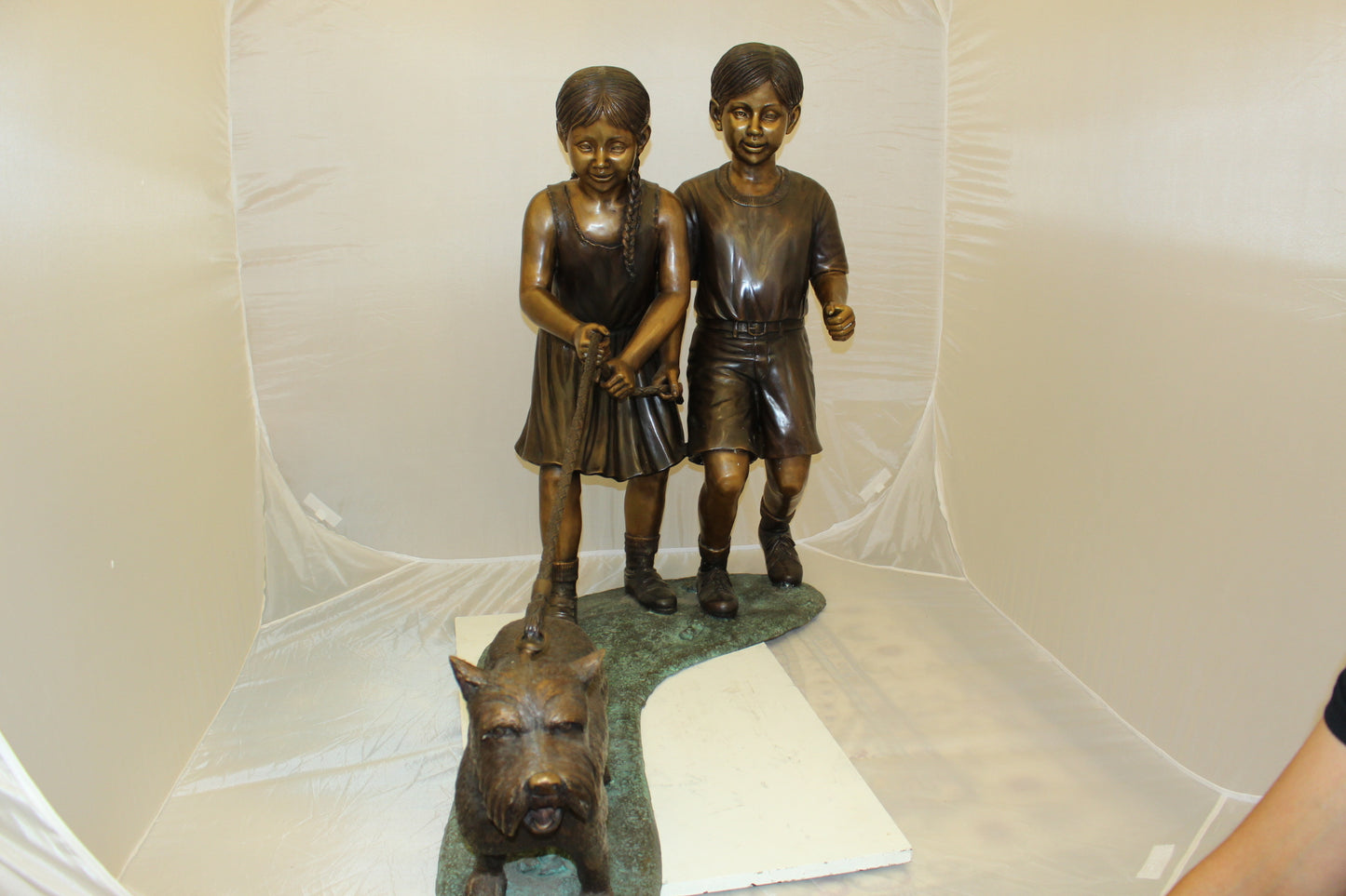 Two Kids Walking a dog Bronze Statue - Size: 55"L x 28"W x 37"H.