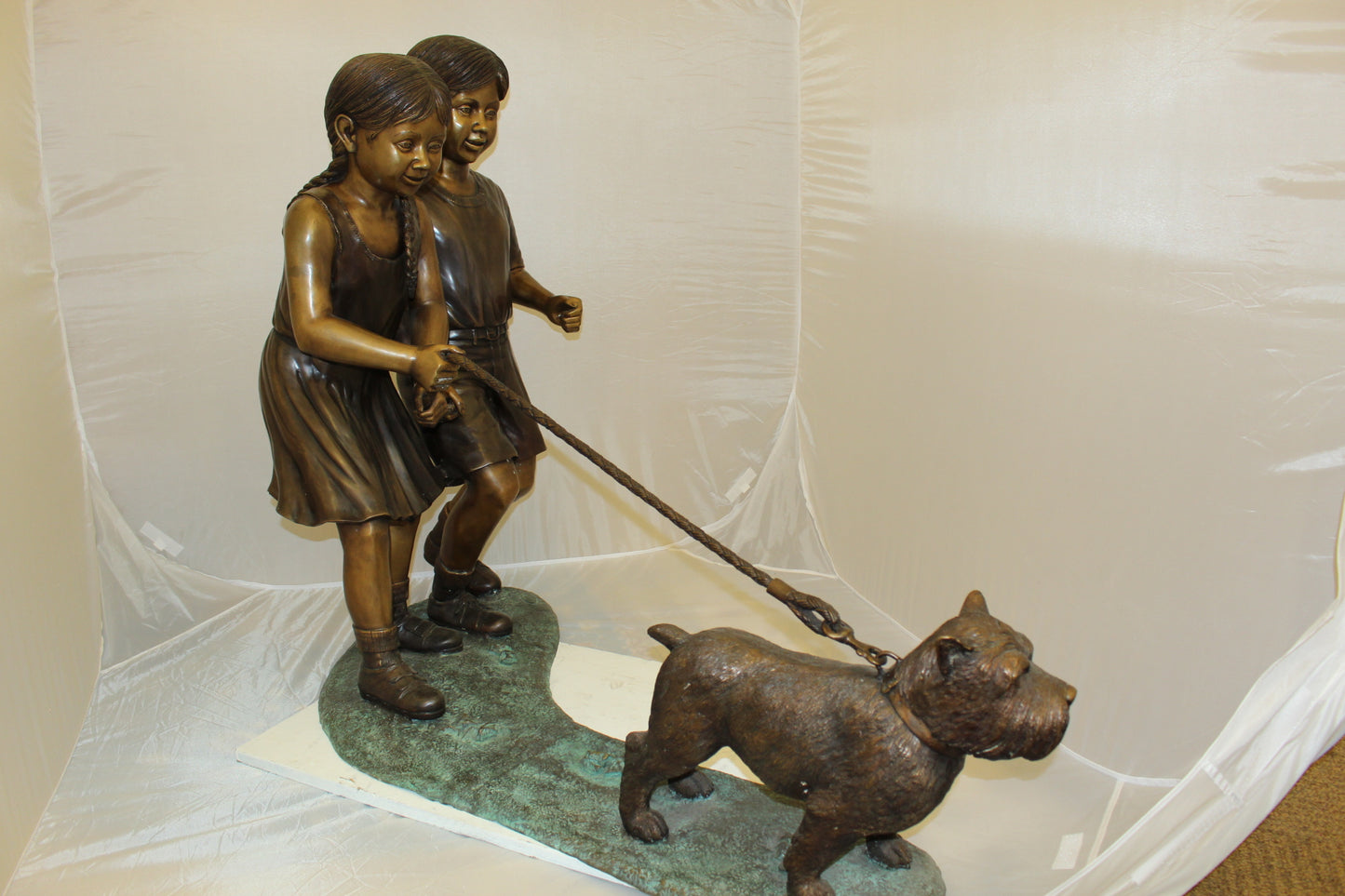 Two Kids Walking a dog Bronze Statue - Size: 55"L x 28"W x 37"H.