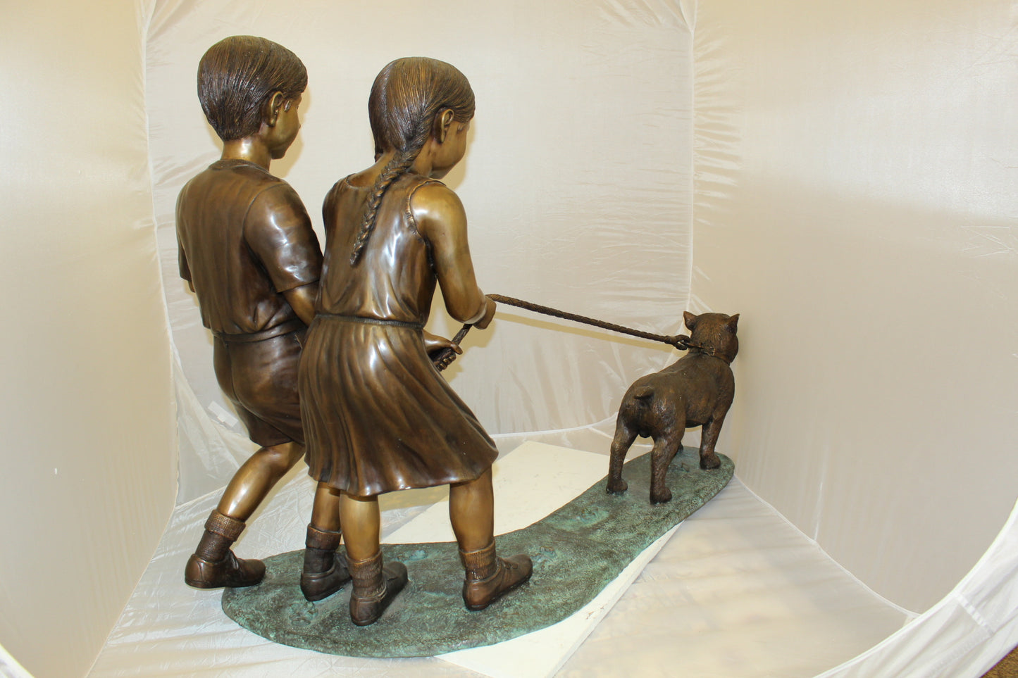 Two Kids Walking a dog Bronze Statue - Size: 55"L x 28"W x 37"H.