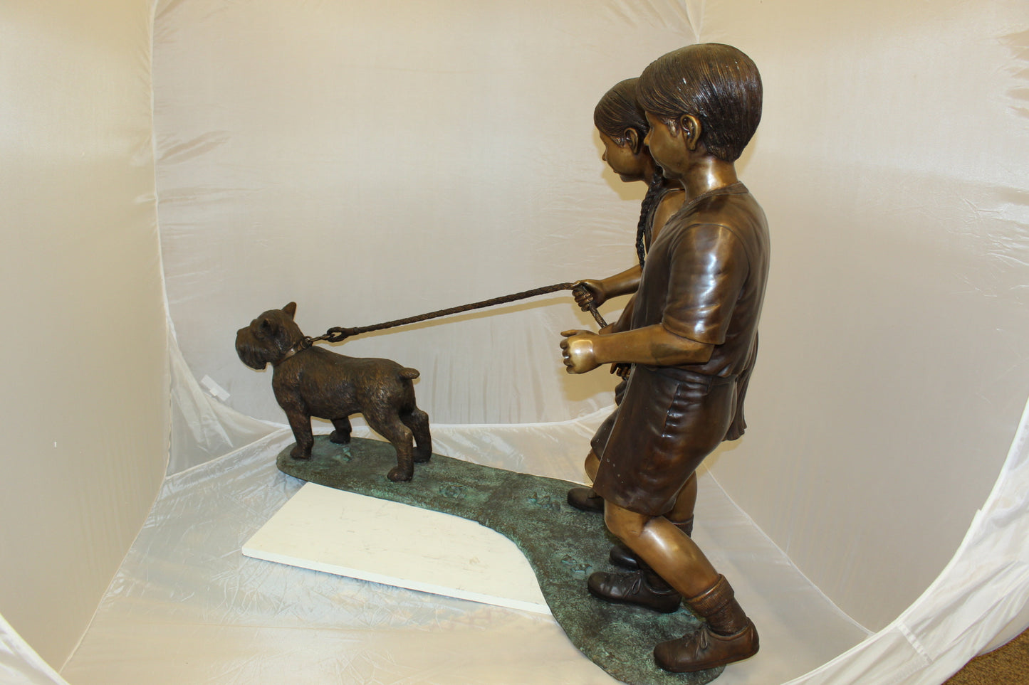 Two Kids Walking a dog Bronze Statue - Size: 55"L x 28"W x 37"H.