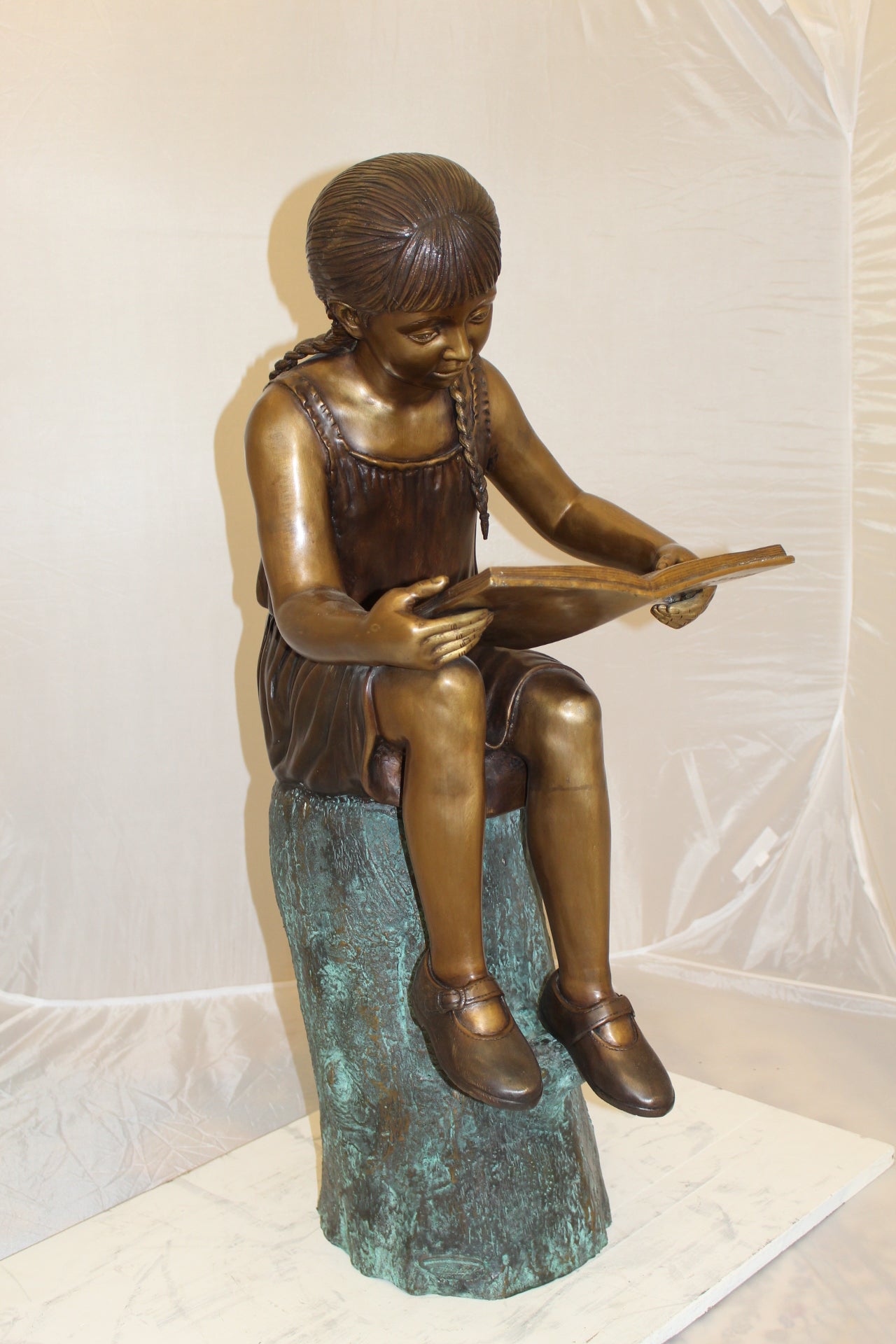 Girl Sitting on a Tree Stump Reading a Book Bronze Statue - 15"L x 17"W x 38"H