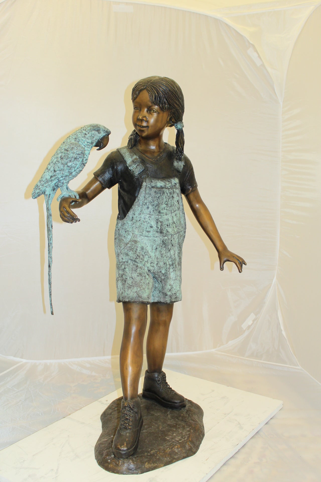 Girl Holding a Parrot Bronze Statue -  Size: 26"L x 19"W x 42"H.