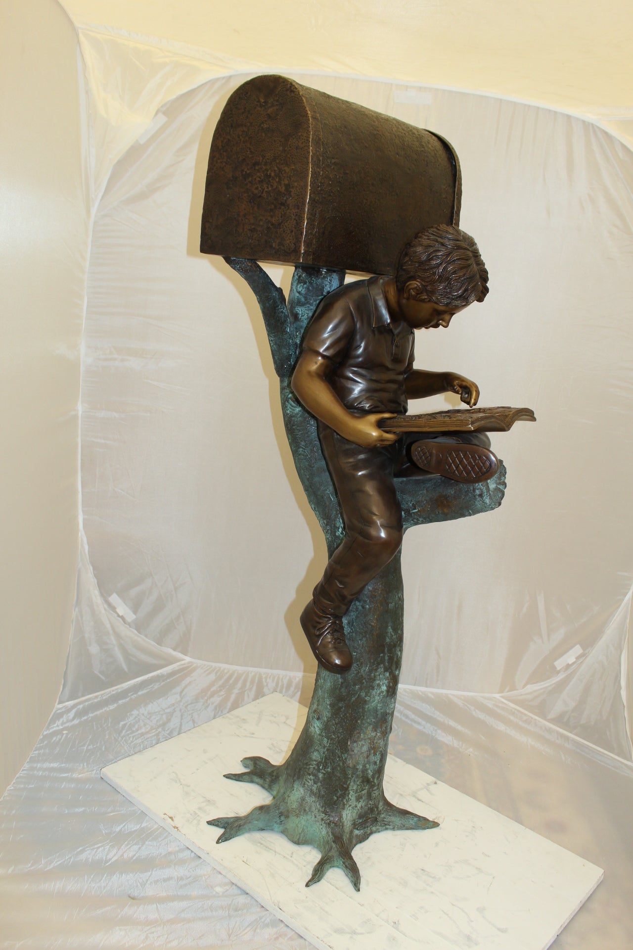 Boy Sitting by a Mailbox reading a book Bronze Statue - 16"L x 20"W x 50"H.