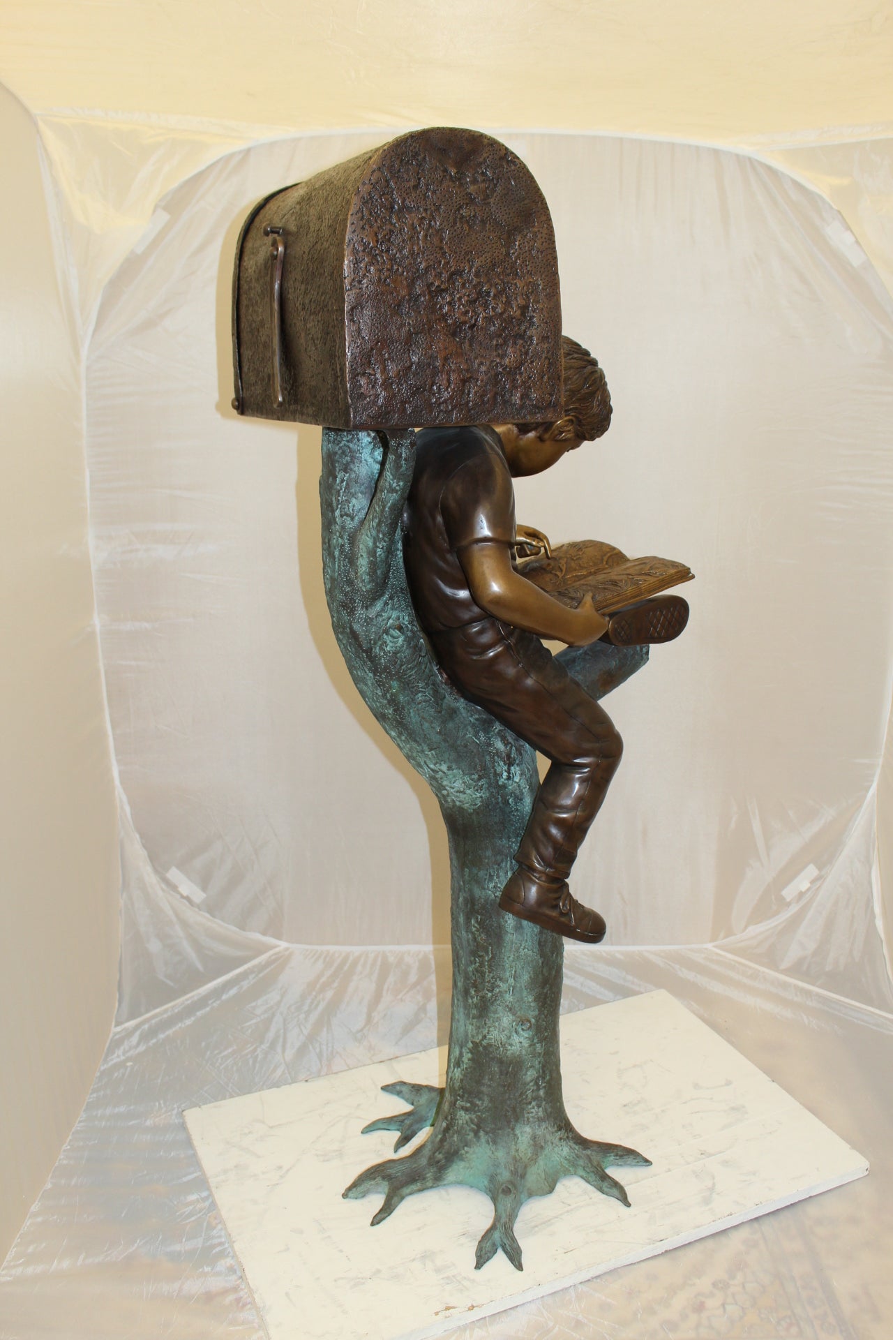 Boy Sitting by a Mailbox reading a book Bronze Statue - 16"L x 20"W x 50"H.