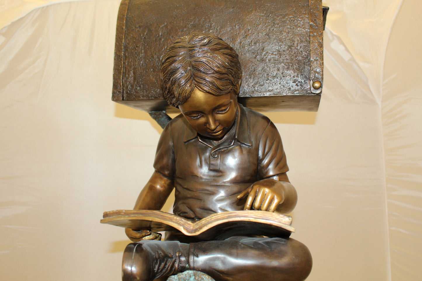 Boy Sitting by a Mailbox reading a book Bronze Statue - 16"L x 20"W x 50"H.