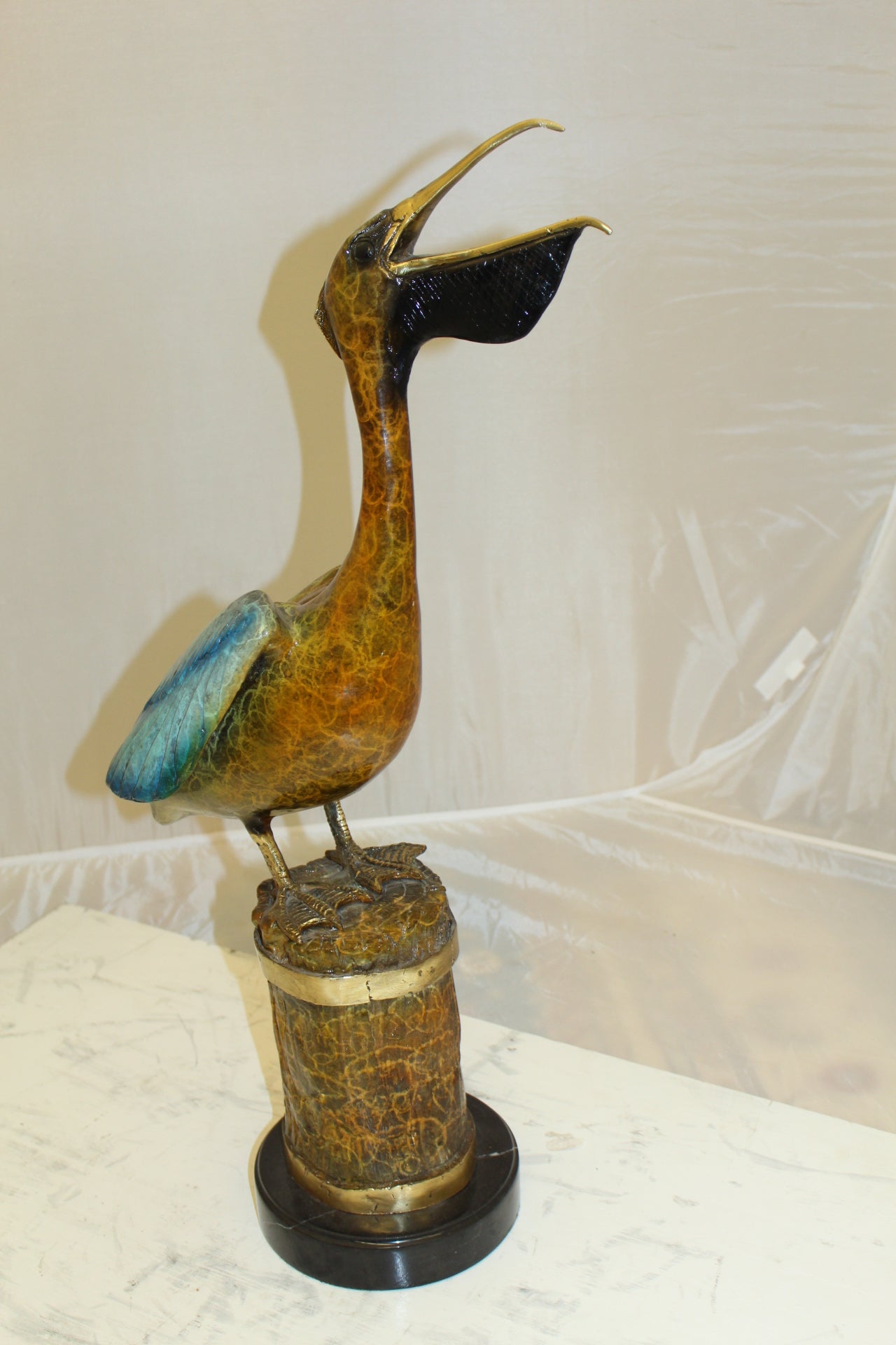 Pelican on a Tree Stump Bronze Statue -  Size: 8"L x 12"W x 27"H.