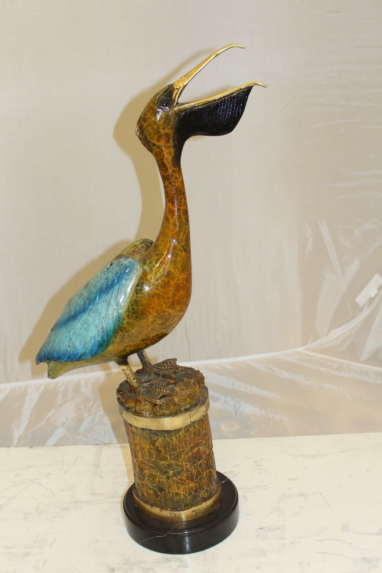 Pelican on a Tree Stump Bronze Statue - Size: 8"L x 12"W x 27"H.