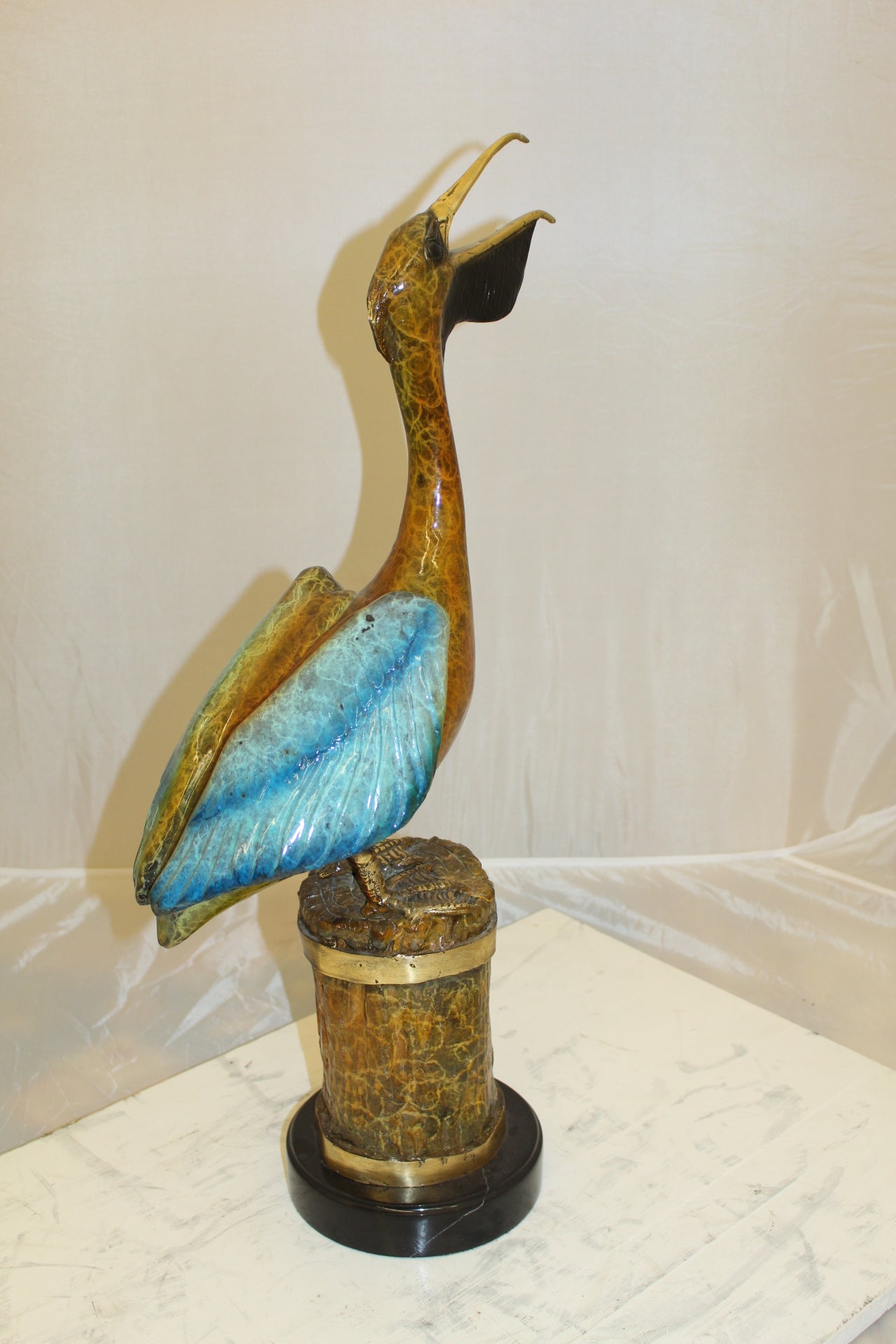 Pelican on a Tree Stump Bronze Statue - Size: 8"L x 12"W x 27"H.