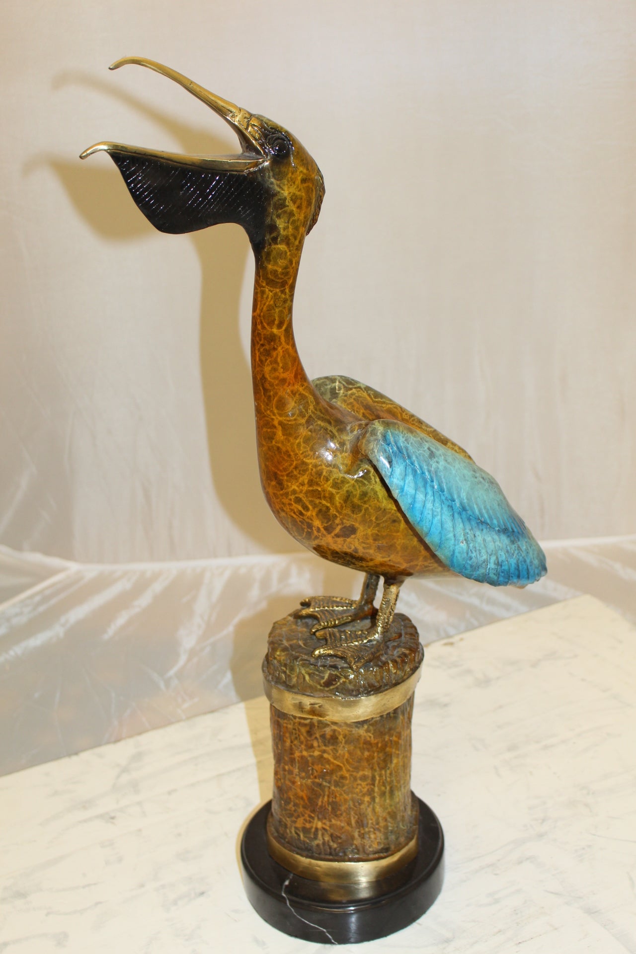 Pelican on a Tree Stump Bronze Statue - Size: 8"L x 12"W x 27"H.