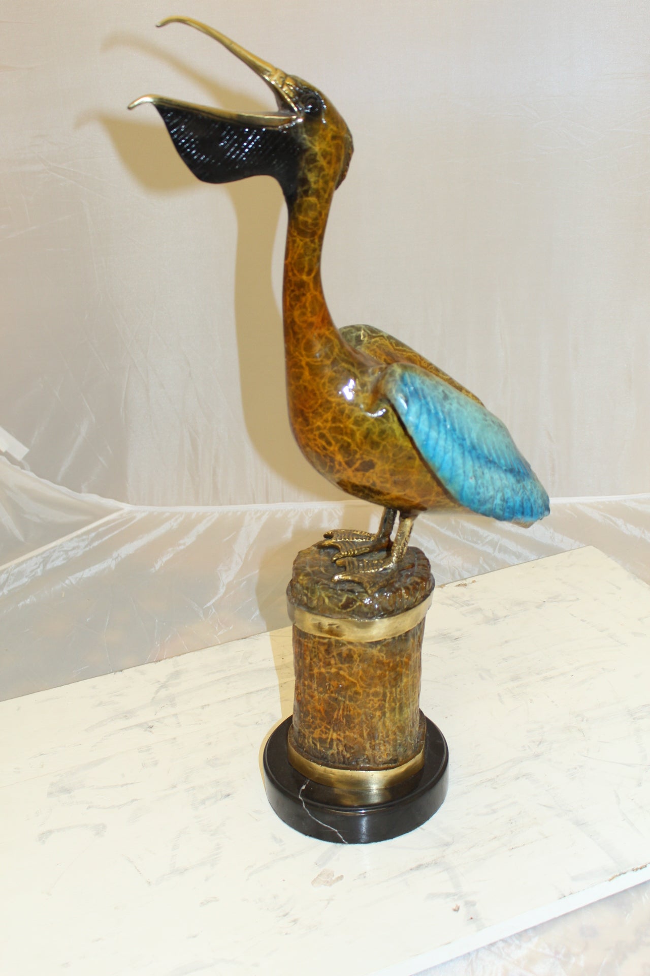 Pelican on a Tree Stump Bronze Statue - Size: 8"L x 12"W x 27"H.