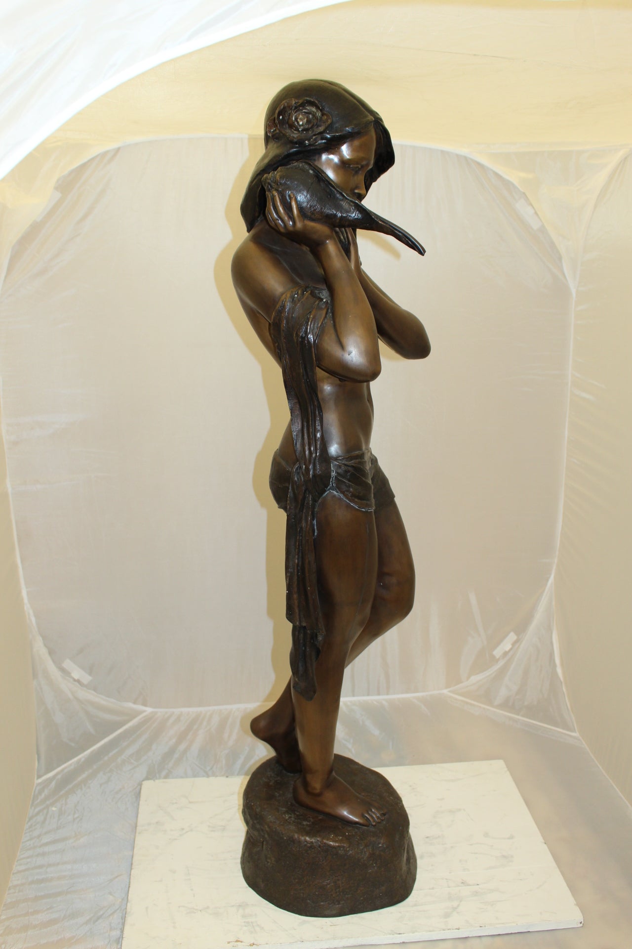 Girl Holding a Sea Shell Bronze Statue - Size: 13"L x 14"W x 57"H.