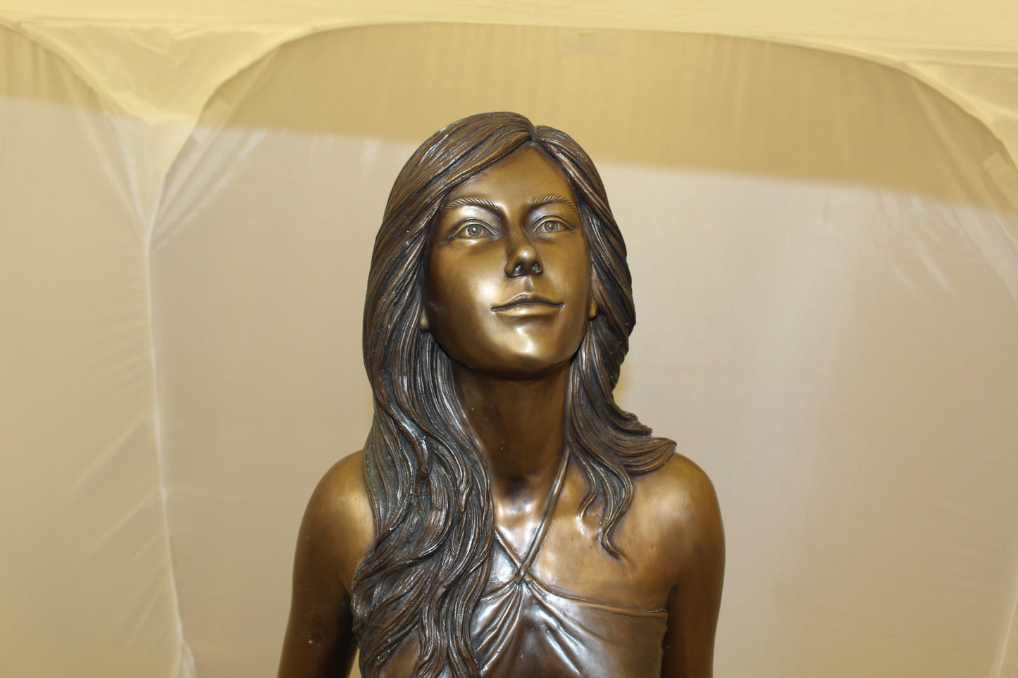 Lady holding her Skirt Bronze Statue - Size: 32"L x 17"W x 53"H.