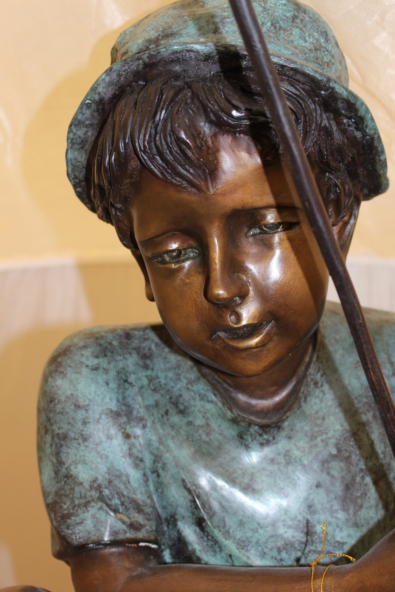 Boy Sitting on a Tree and Fishing Bronze Statue - Size: 36"L x 21"W x 37"H.