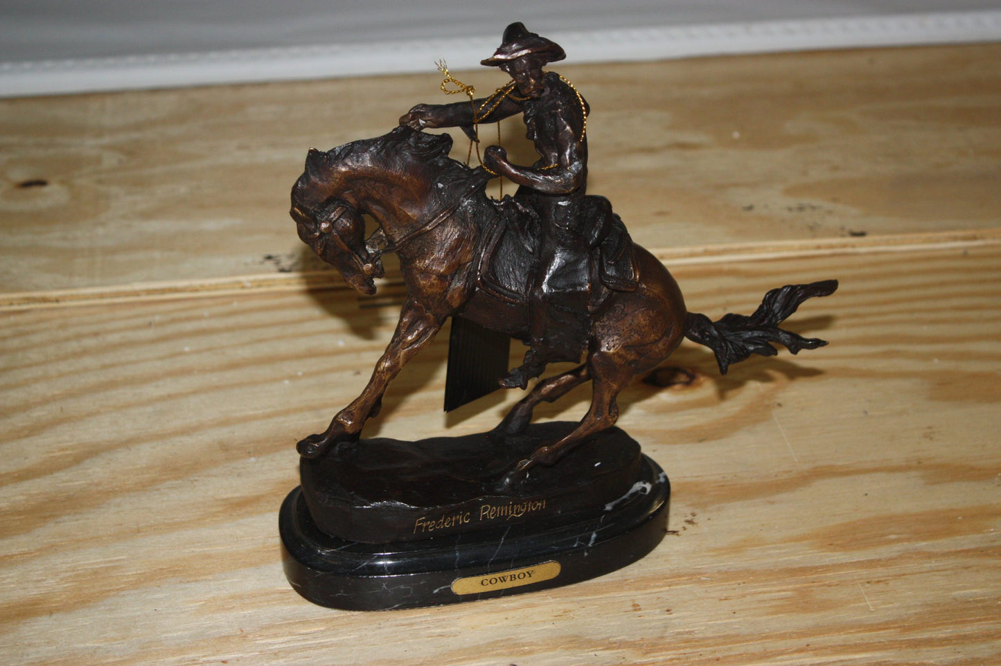 Remington Cowboy on marble Bronze Statue - Size: 10"L x 3.5"W x 10"H.