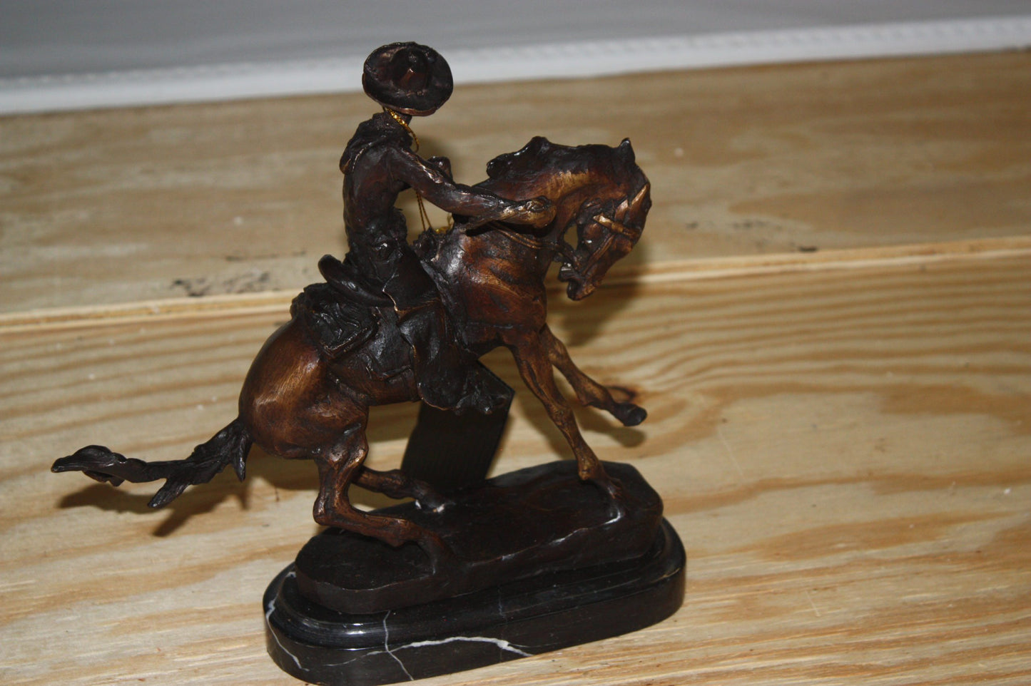 Remington Cowboy on marble Bronze Statue - Size: 10"L x 3.5"W x 10"H.
