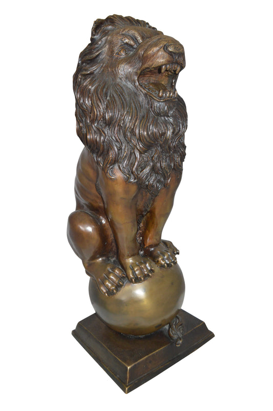 Pair of lions standing on balls, bronze statues - Size: 14"L x 16"W x 38"H.